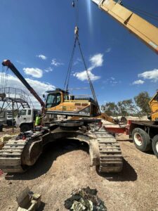 Crane lifting Cab from Excavator